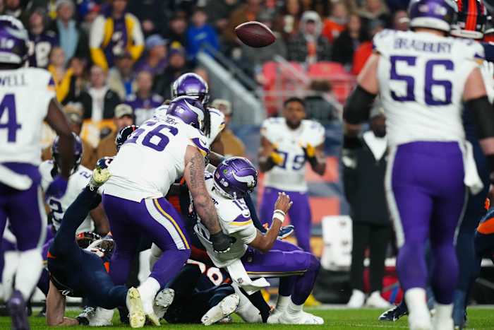 Minnesota Vikings quarterback Joshua Dobb fumbles against the Denver Broncos in the first quarter at Empower Field at Mile High.